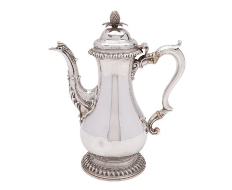 A George III silver coffee pot, maker's mark *J.S, London 1770, the domed lid with pineapple finial, gadrooned rim, plain bal