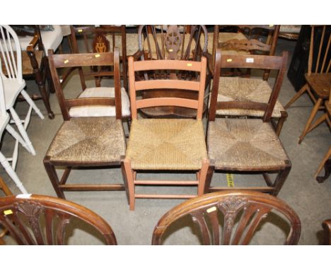 A pair of antique rush seated bar back dining chairs; and a painted ladder back chair with string seat