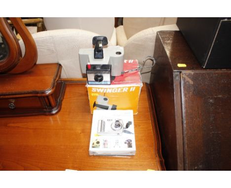 A Swinger 2 Polaroid camera; and a digital camera 