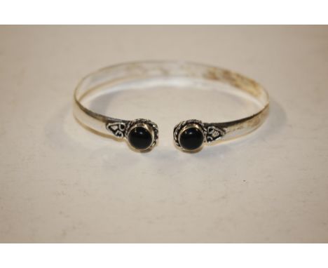 A boxed white metal and onyx set bangle 