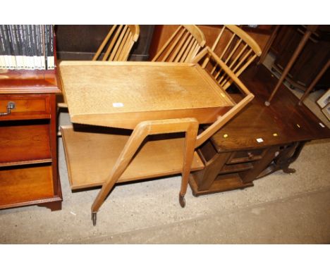 A 1950's light oak two tier trolley fitted drawer
