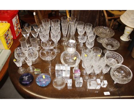 A collection of various table glassware to include decanters, Champagne saucers, flutes and wines, paperweights etc. 