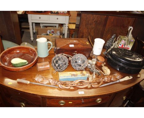 A 19th Century mahogany sarcophagus shaped tea caddy  AF; two glass fisherman's floats; a carved wooden fertility chain; an e