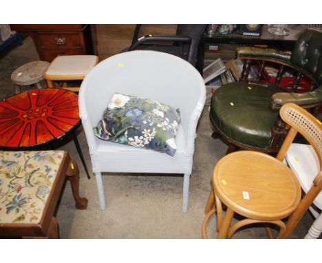 A pale blue painted loom tub shaped chair and cushion