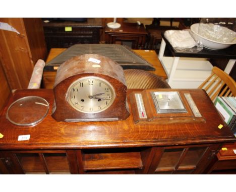 An oak cased mantel clock and a barometer thermometer 