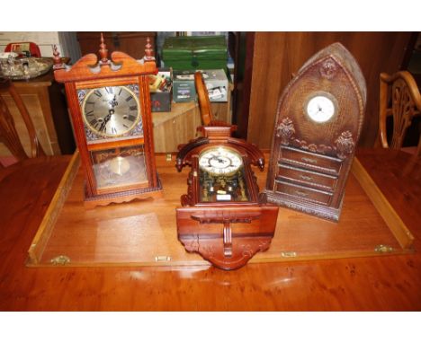 A 31 day wall clock; a similar mantel clock; and a lancet shaped leatherette embossed case quartz timepiece fitted three draw