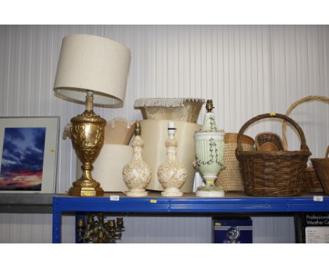 A gilt cherub decorated table lamp with shade and three other table lamps