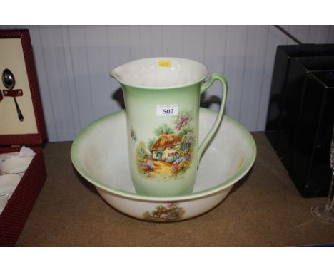 An Edwardian toilet jug and basin decorated 'homestead' pattern