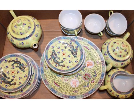 A collection of tea and dinner ware in the 'Chinese Dragon Yellow' pattern to include tea pot, cream and sugar, six trios, an
