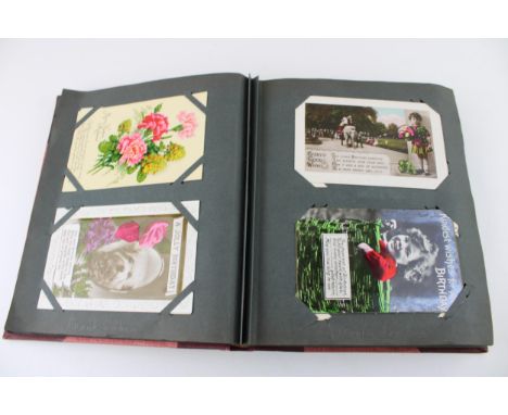 A postcard album containing late 19th and early 20th century postcards on subjects 'Birthday Greeting Cards', 'Novelty Cards'