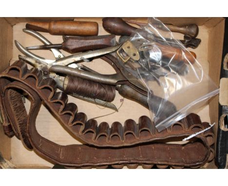 A collection of vintage leather workers tools together with a vintage leather cartridge belt. (Qty)