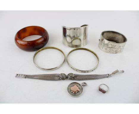 A group of silver jewellery comprising a cuff bangle, marked 925, a Mexican silver bangle engraved with 'XoooX, simple bangle