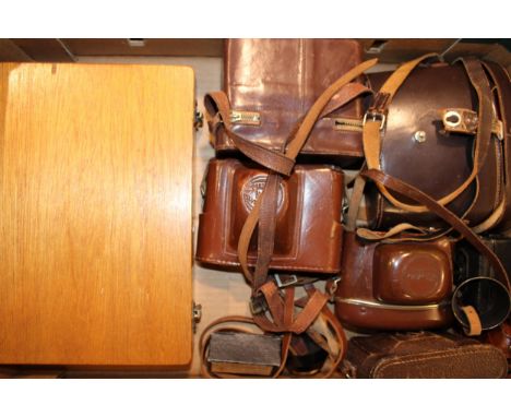 A collection of vintage camera equipment and a pair of binoculars by Ross '9x35 Stepruva'. Camera equipment includes Zeiss Ic