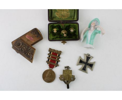 A collection of items to include a ceramic pin doll, a snuff box, a pair of medals, a military cap badge and a box of collar 