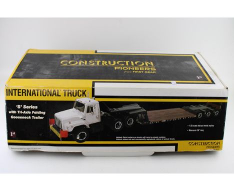 Construction Pioneers from 1:25 scale First Gear 'International 'S' Series Truck with Tri-Axle Folding Gooseneck Trailer.  In