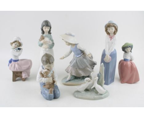 A collection of Nao figures to include a boy with his dog, a girl with a dog seated and others (7).  Generally good condition