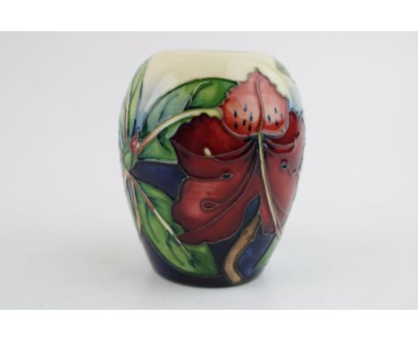 A Moorcroft pottery squat vase in the 'Simeon' pattern. Height 9.5cm.  Of second quality (silver line) with no obvious signs 