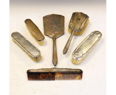 George VI engine turned silver backed three piece brush set, Birmingham 1947, together with two other silver backed brushes a