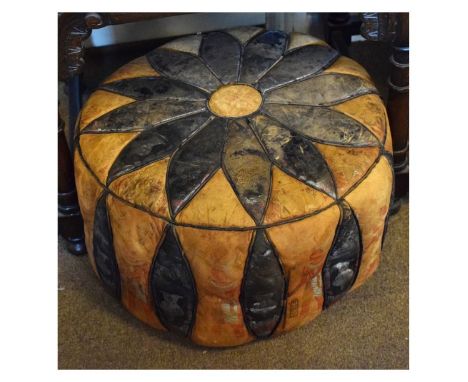 Vintage two-colour leather pouffe of circular form with flowerhead decoration, 51cm diameter x 27cm high   Condition: 