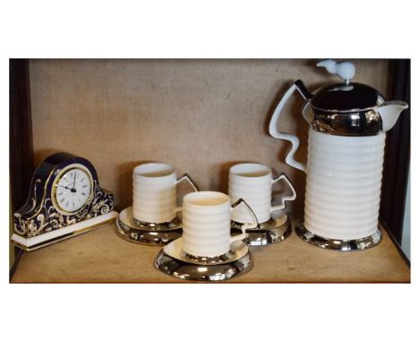 Cosmic Design Works coffee pot, three cans and three saucers, together with a Wedgwood Cornucopia mantel clock (8)   Conditio