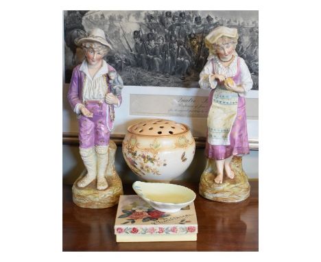 Pair of early 20th Century Continental bisque porcelain figures of a street showman with monkey holding his hand out for a co