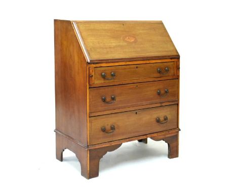 Early 20th Century inlaid mahogany bureau, the satinwood, ebony and boxwood strung fall with central shelf patera over three 