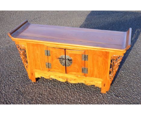 Chinese hardwood low altar style table cabinet, the top with upturned sides above 2 panel doors enclosing a shelf, flanked by