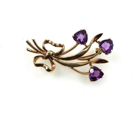 9ct gold and amethyst floral brooch set three stones, length 4.1 cm, gross 5.2 grams 
