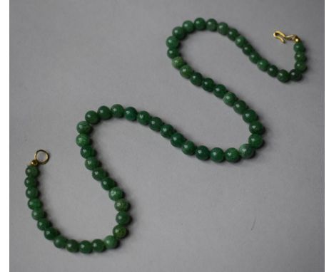 A String of Circular Jade Beads, 41cm Long 