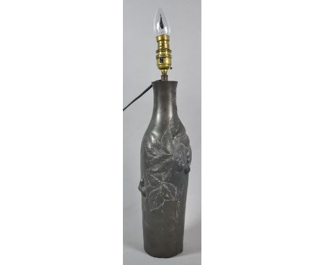 An Early 20th Century Bottle Shaped Pewter Table Lamp Base Decorated in Relief with Leaves and Nuts, 36cm high 
