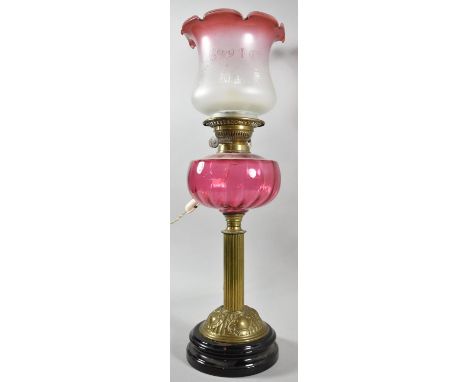 A Late Victorian Oil Lamp with Cranberry Glass Reservoir and Opaque Etched Shade, the Stand in the Form of a Reeded Column, C