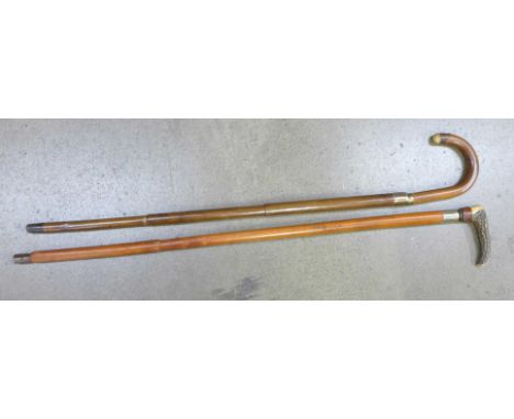 Two walking sticks, one with an internal measuring stick, one with an umbrella 