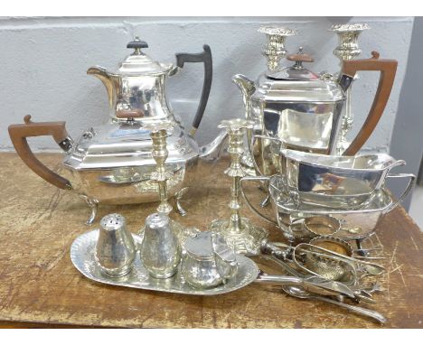 A pair of plated candlesticks, a four piece plated tea service and other plated items 