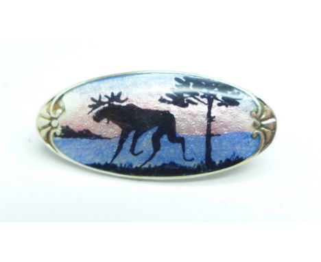 A small silver and enamel brooch, possibly Scandinavian, reindeer winter scene 