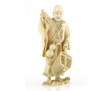 An ivory okimono carved as a standing lobster fisherman, holding a crustacean in his right hand and a net in his left hand; a