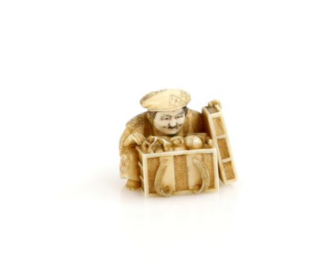 A stained ivory netsuke carved as Daikoku, or another character, taking the lid off a box of treasure, 20th CenturyProvenance