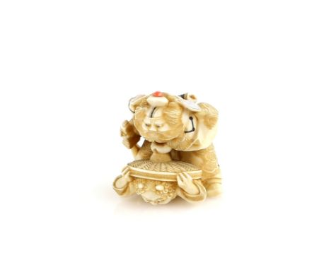 An ivory netsuke of Shoki trapping an Oni under his hat, signed YoshitaniProvenance: The Property of a Lady. From a Private C