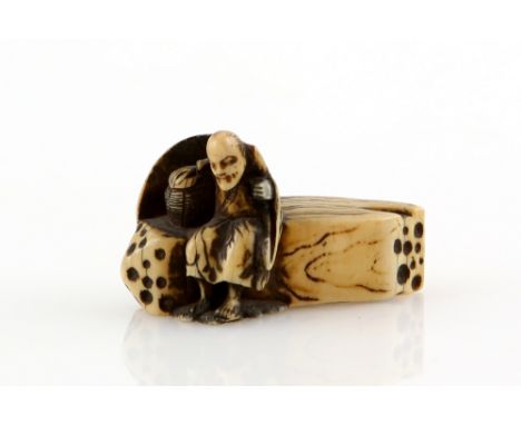 A stained ivory netsuke carved as the aged poetess, Sotoba Komachi seated on a log or grave marker, un-signedProvenance: The 