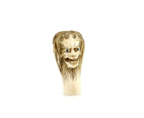 An ivory cane or parasol handle carved with a grotesque head, 6 cm high, 20th  CenturyProvenance: The Property of a Lady. Fro