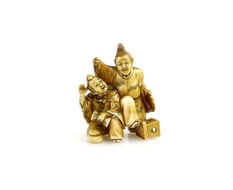 A stained ivory netsuke of two Manzai Dancers, one playing a tsuzumi; 19th or 20th CenturyProvenance: The Property of a Lady.