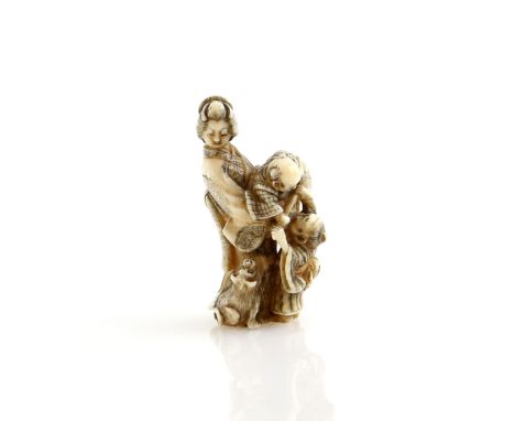 A stained ivory netsuke carved as a standing Yamato Nadeshko with two children and a dog, signed HominProvenance: The Propert