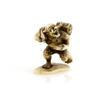 An ivory netsuke or small okimono, carved as a running Oni with a bag of makemono, unsigned, 19th CenturyProvenance: The Prop