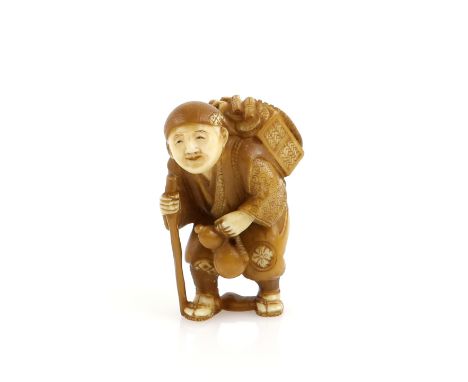 A stained ivory netsuke of a standing traveller with a stick and back pack, 20th CenturyProvenance: The Property of a Lady. F