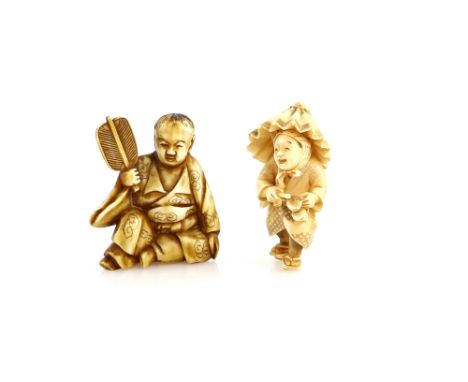 A stained ivory okimono of a boy, holding a fan; and a standing man holding a broken umbrella and wearing geta, both 20th Cen