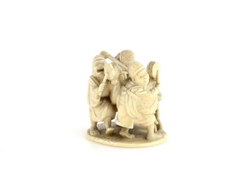 An okimono style ivory netsuke with central himotoshi, carved as group of dancers and musicians, signed Tokosai Tomoaki Prove