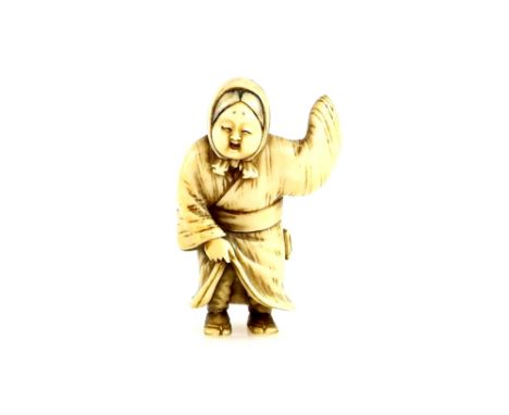 An ivory netsuke of Okame, wearing a netsuke and pipe case on her obi, and holding the hem of her kimono, unsigned,  early 19