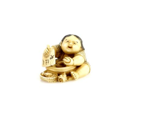 A large stained ivory netsuke of a boy eating shell fish, 20th CenturyProvenance: The Property of a Lady. From a Private Coll