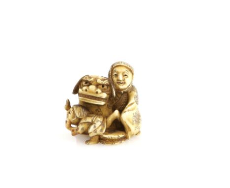 A stained ivory netsuke of a Shishimai performer beside a child, 19th or 20th CenturyProvenance: The Property of a Lady. From