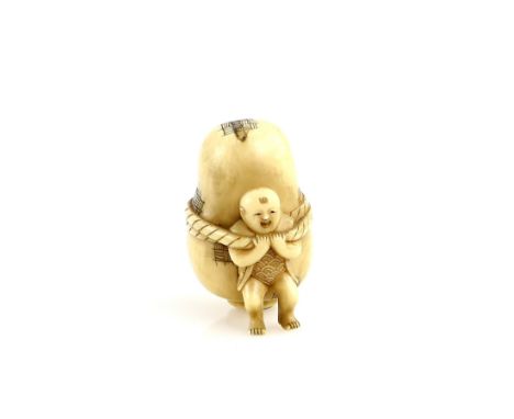 An ivory netsuke of a boy holding a large Daruma style doll with revolving interior portraying three separate faces, un-signe