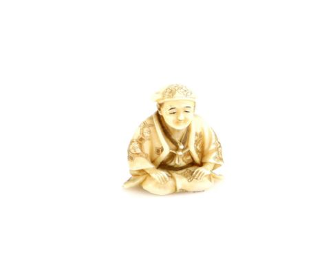 A stained ivory netsuke of a kneeling man, signed SeigyokuProvenance: The Property of a Lady. From a Private Collection acqui